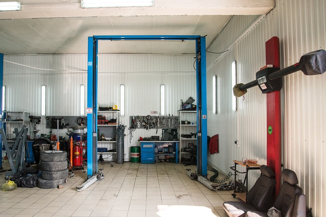 Clean workshop with a two-post car lift